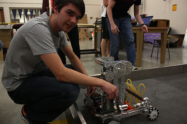 Junior Matt McClain working with his robot after school.