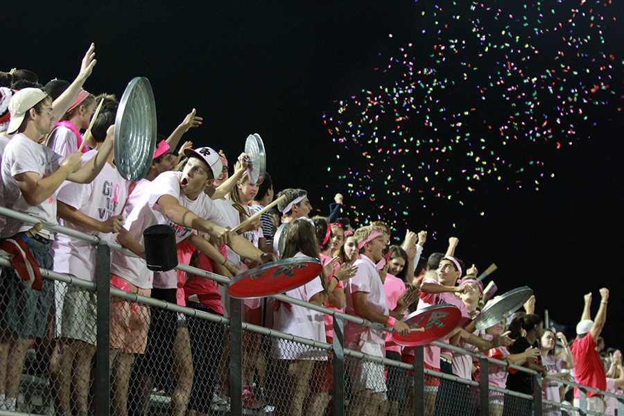 Cheering at the Vandegrift game on Oct. 10, the student section throws confetti, a banned item at Gupton Stadium. Students also threw water in unison, and were later reprimanded for the act. 