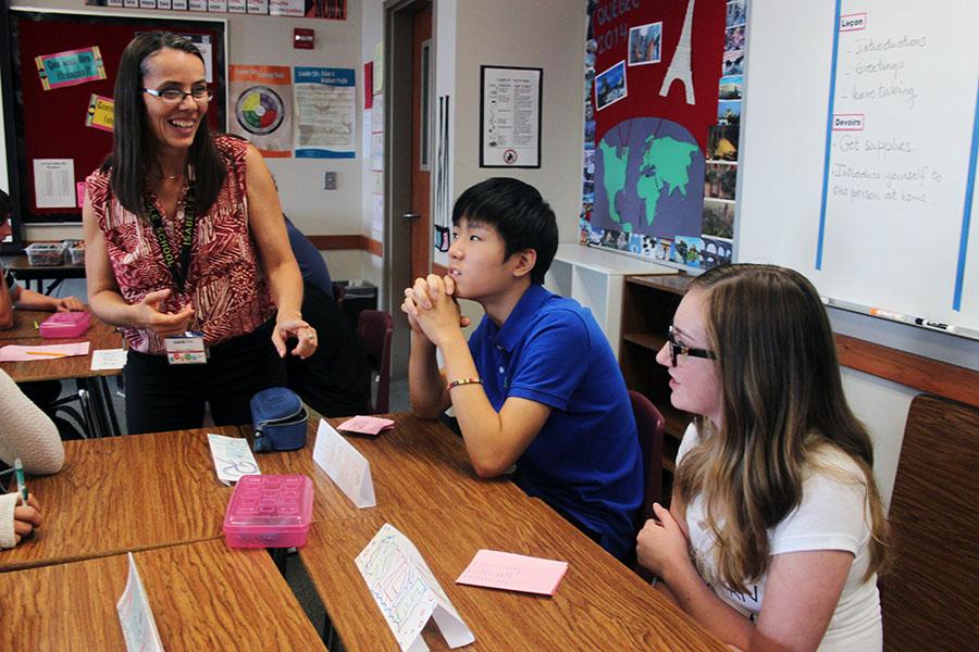 French teacher Isabelle Cate greets her students on the first day of class during 6th period.