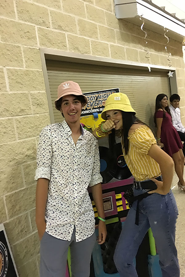 Wearing+matching+bucket+hats%2C+Constantinos+Malliaros+attends+his+first+homecoming+dance+with+Larsen+Simecek.+The+dance+was+themed+Saturday+Night+Fever+and+started+at+8pm.