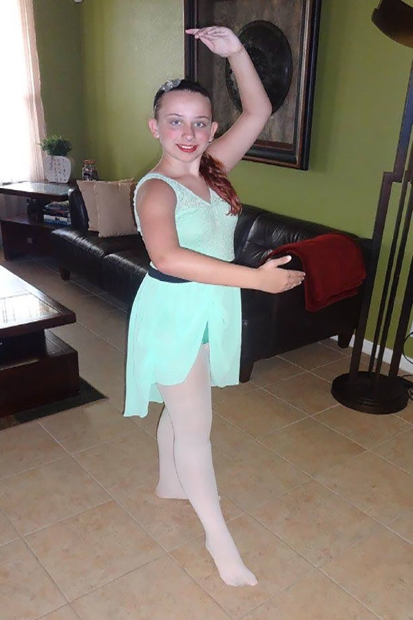 Preparing for her performance, Emiley Abbett poses for a photo. Starting to teach two months prior to now, Abbett has been at the Joyce Willett dance studio since the age of two.