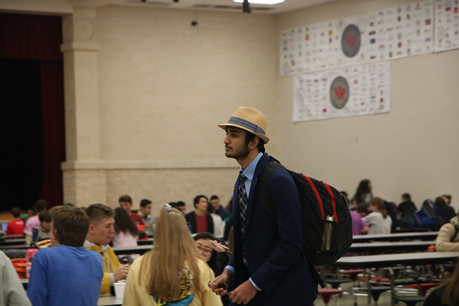 Walking through the cafeteria, Moustafa Neematallah is asked to take off his hat by the nearest AP.