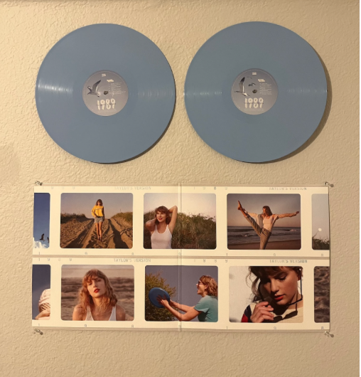 A 1989 (Taylor’s Version) Crystal Skies Vinyl hangs on Ada Myricks wall, along with her collection of other Swift albums.