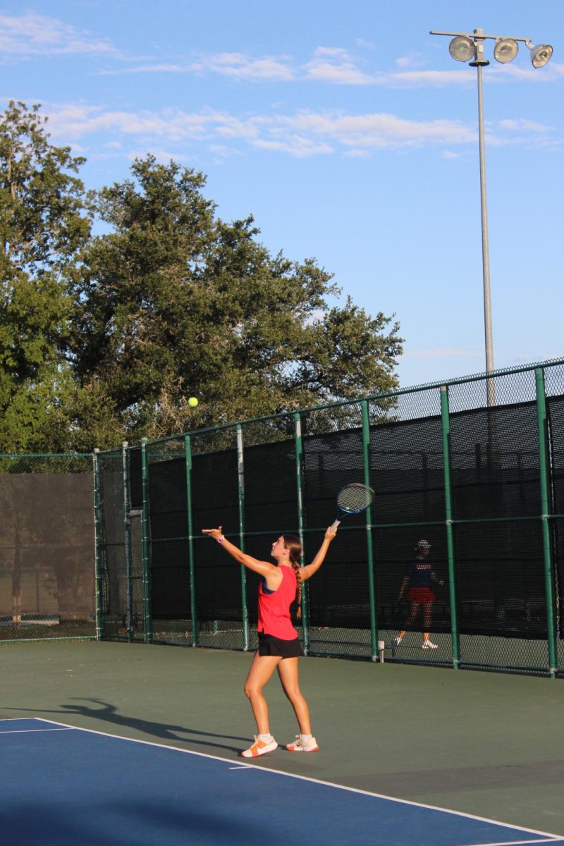 Senior, Brecken Rider serving the ball in her match against Leander HS.