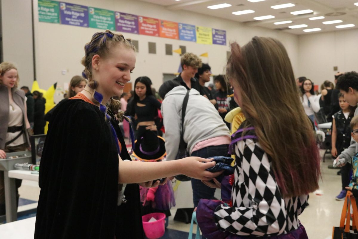 During last years Trunk or Treat, Eleanor Ronan passes out candy for Key Club.