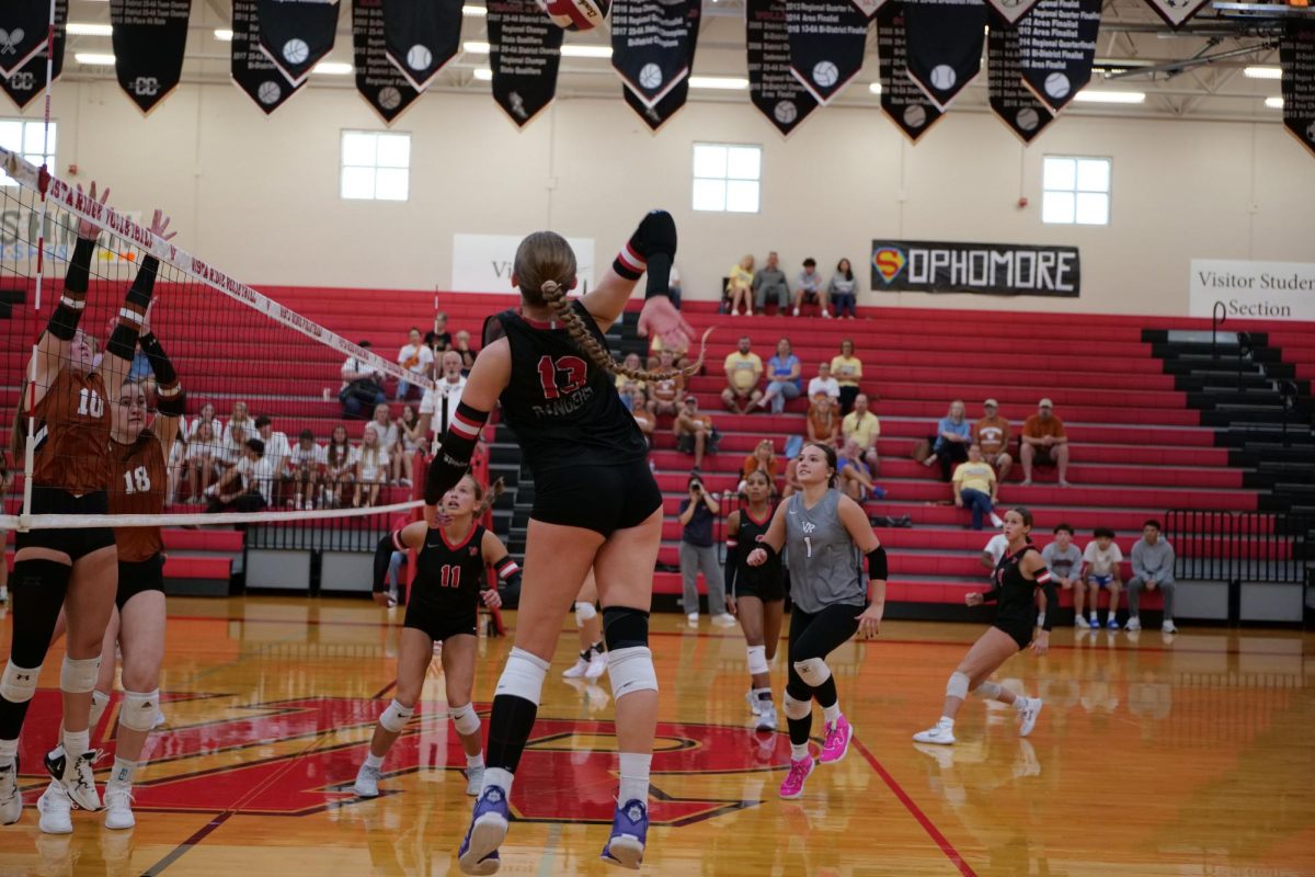 Junior Jennavee Jensen spikes the ball, right side over the net scoring Vista a point during set 2