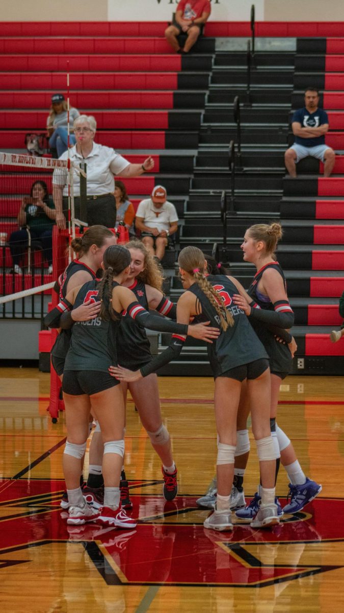 Varsity Volleyball team celebrate after a perfect a point straight down the net against McNeil.