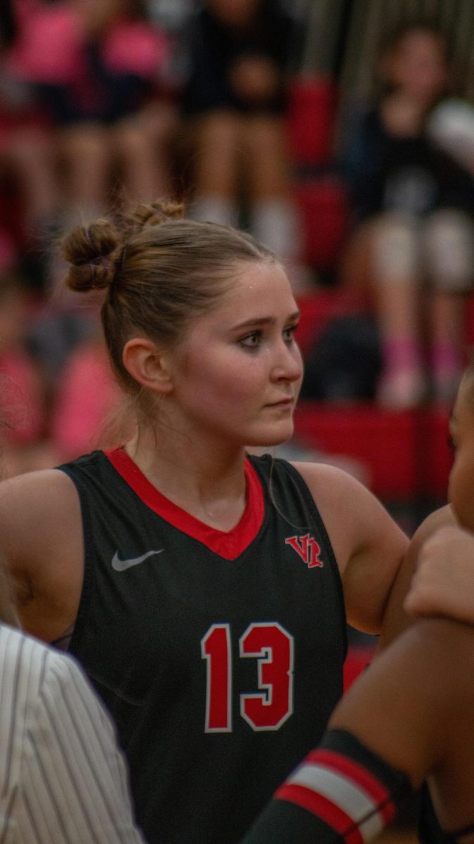 Junior Opposite Hitter Jennavee Jensen is locked in hearing what the coach have to say for the next play, dominating McNeil varsity Volleyball team.