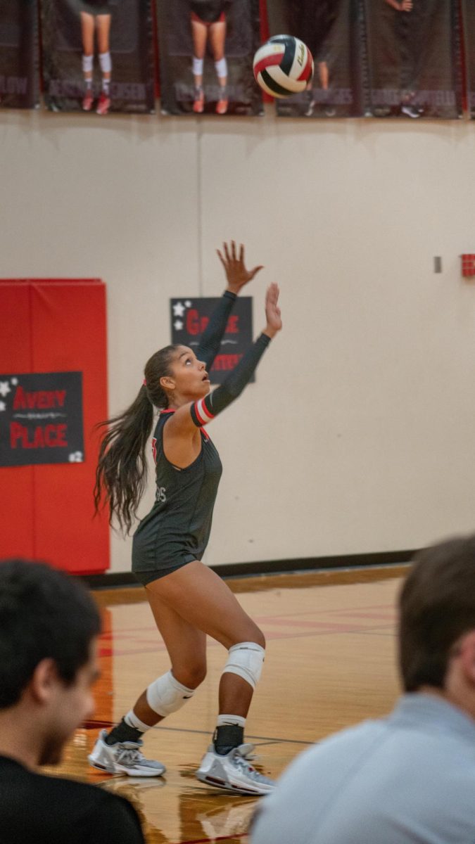 Senior Setter Jasmin Dion staying low for a perfect serve to dominate the McNeil Team.
