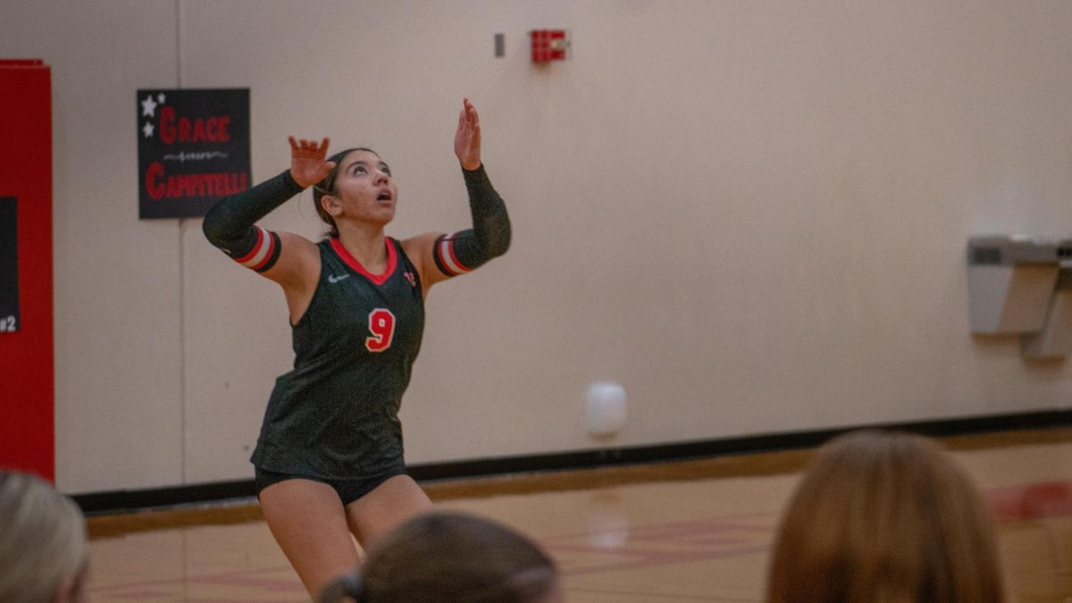 Junior Defensive Specialist Danica Puepke staying low for a powerful serve to dominate the McNeil Volleyball team. 