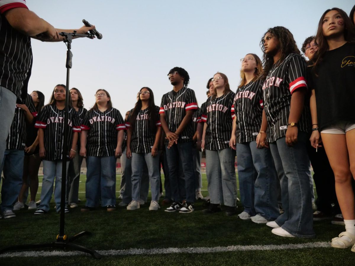 Ovation Choir prepares to sing the national anthem at Vista Ridge's varsity football game against McNeil.