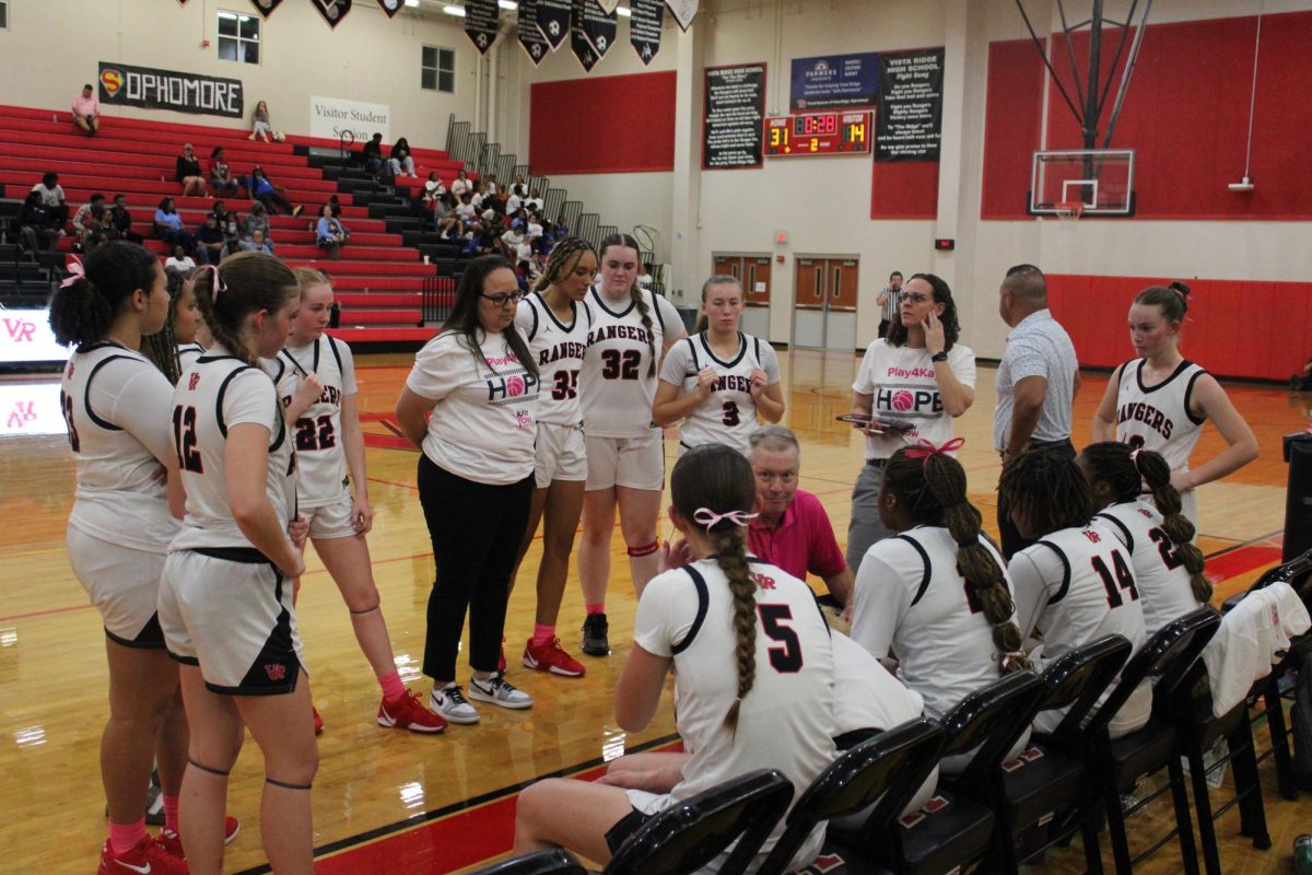 Varsity girls and their coach gather together to explore new ways of beating Pflugerville. 