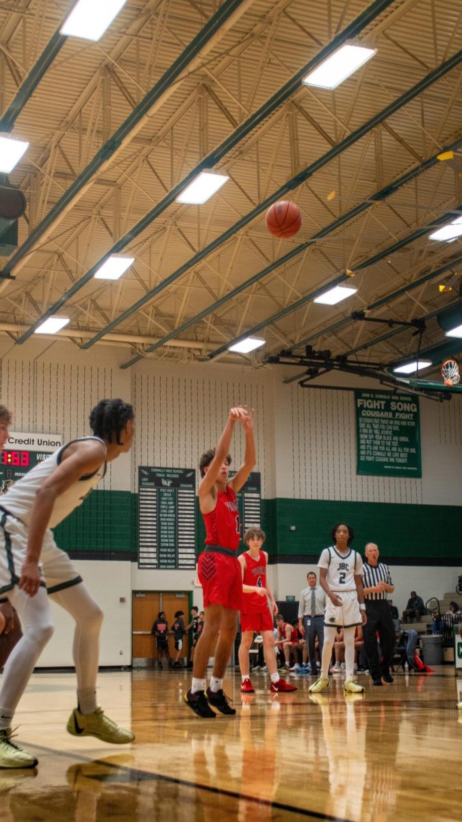 Junior Point Guard Cayden Sneed goes for the three pointer to oppress Connally.