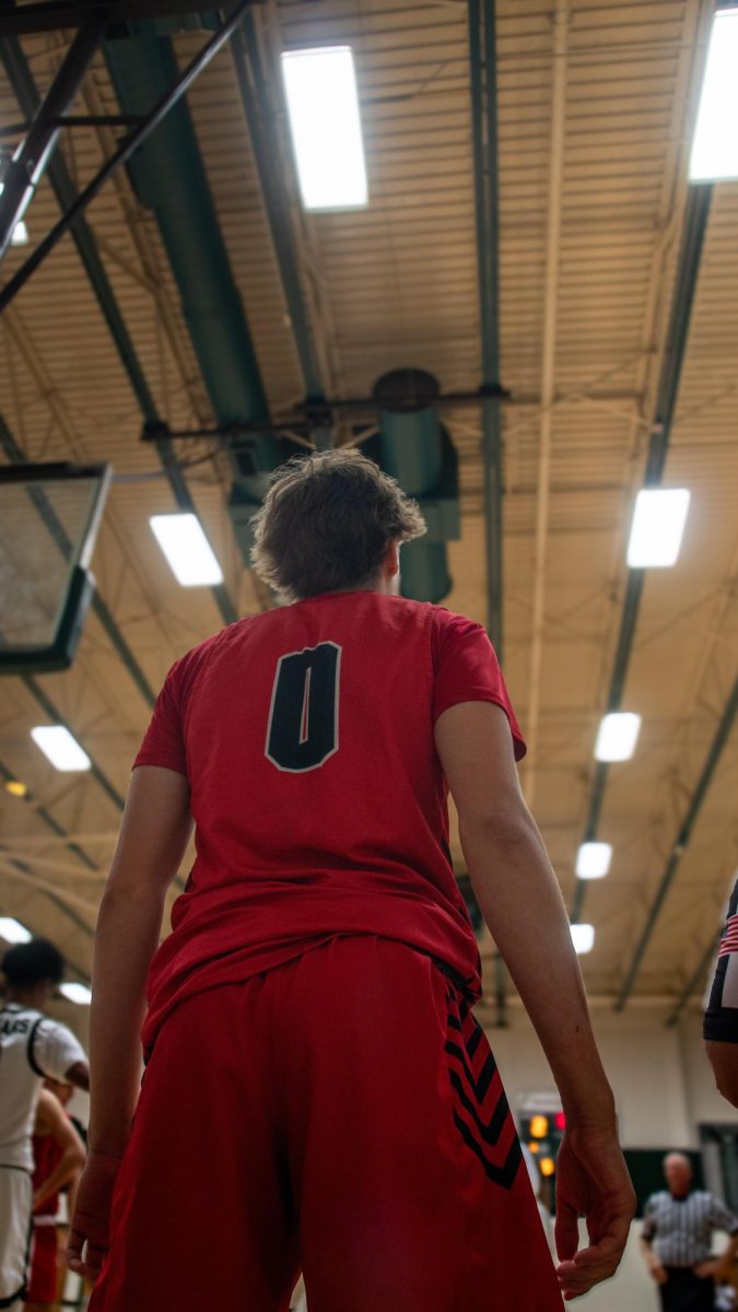 Junior Shooting Guard Christian Cotton Scans the court to make play against Connally