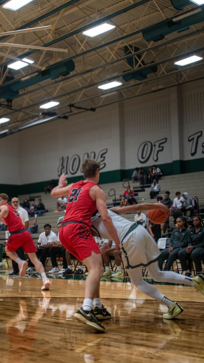 Junior Power Forward Gavin Howard barricades Connally's way to dominate their play.