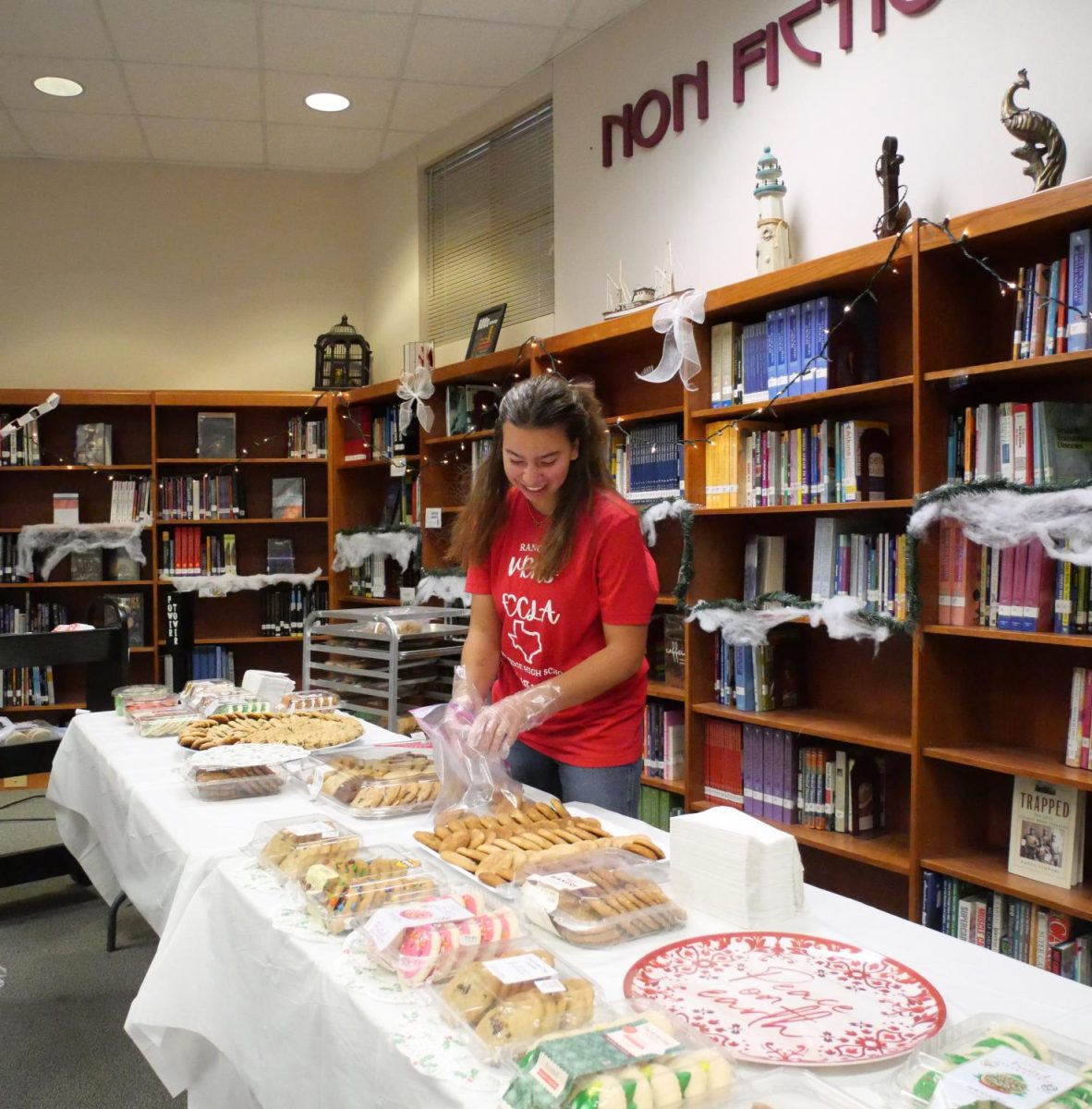 FCCLA member, Robin Hargrove, excitedly prepares the cookies for students to buy during Blue Santa.