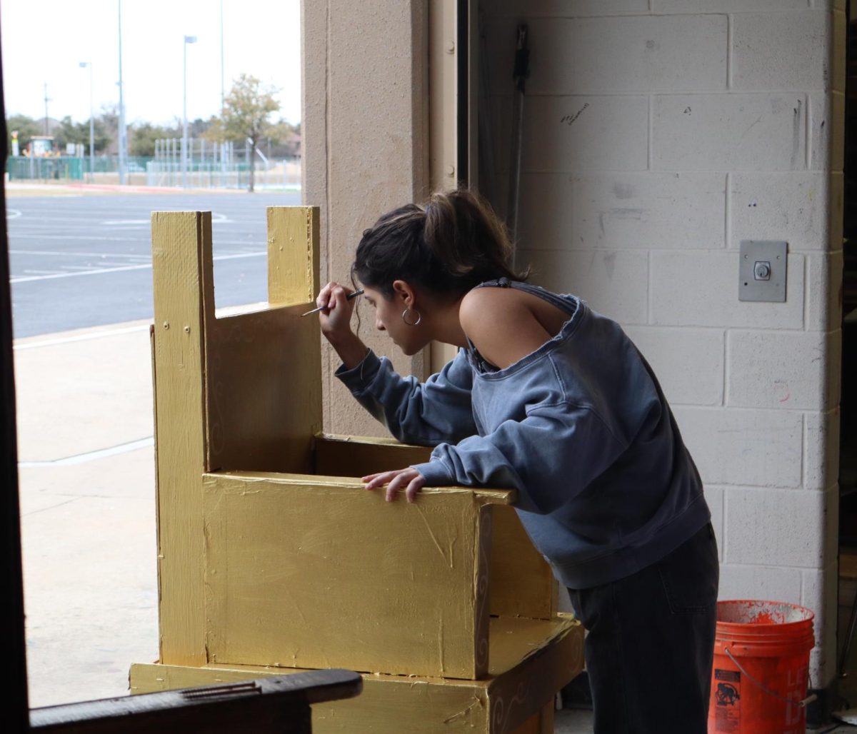 Paint Head Carly Klein attentively works on the design for one the royal thrones.