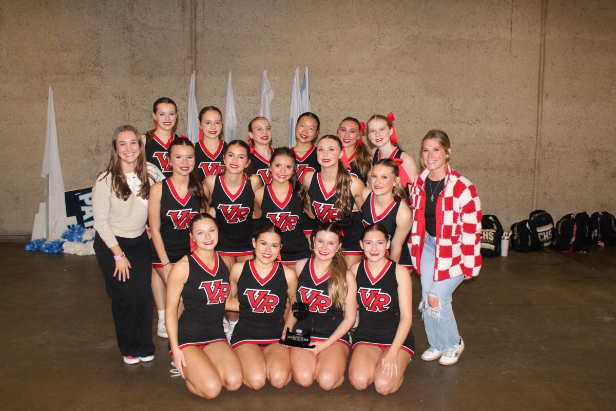 VR cheer team all together, holding their 7th place trophy. 